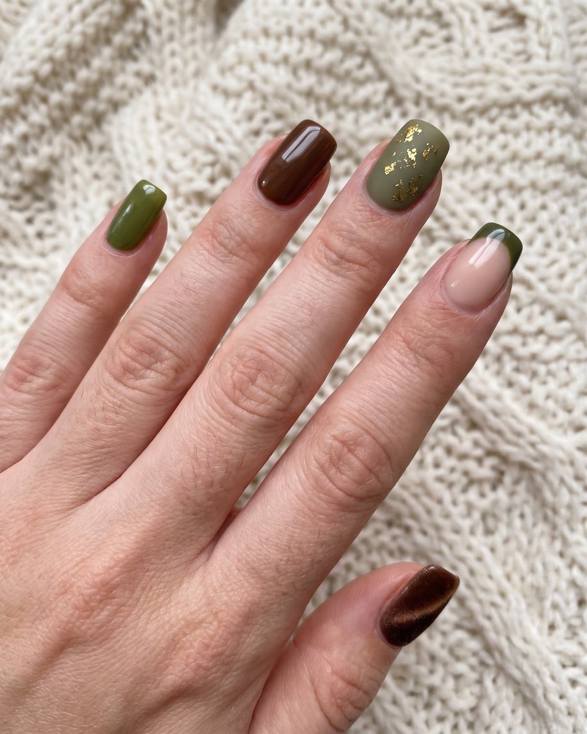 Olive green, chocolate brown and nude almond nails with gold foil and velvet shimmer on a cream background